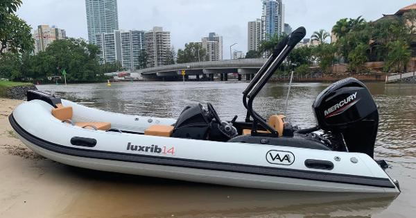 Aqvaboats LUXRIB 14 2024 Aqvaboats LUXRIB 14 inflatable boat on riverbank with cityscape background.