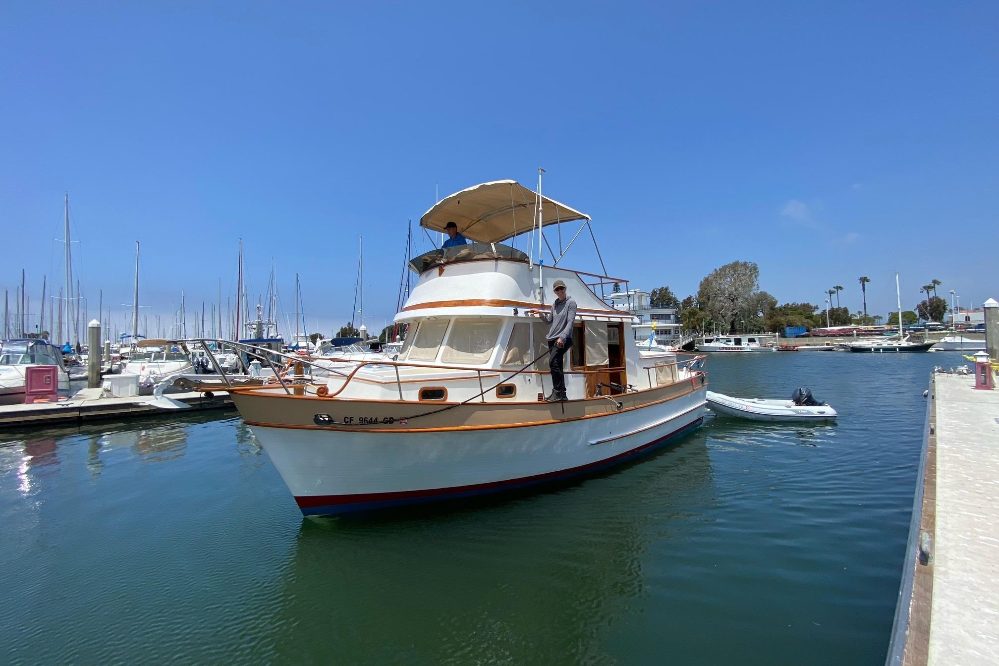 CHB 34 1977 CHB 34 boat docked in a marina under clear blue skies.