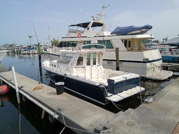 Albin 31 Tournament Express 1996 Albin 31 Tournament Express docked at marina, alongside larger yacht.
