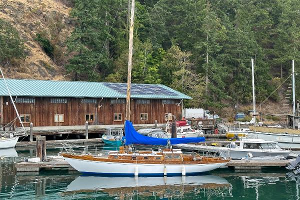 Cheoy Lee Lion Class Sloop 1964 Cheoy Lee Lion Class Sloop docked at a marina with a wooden building in the background.