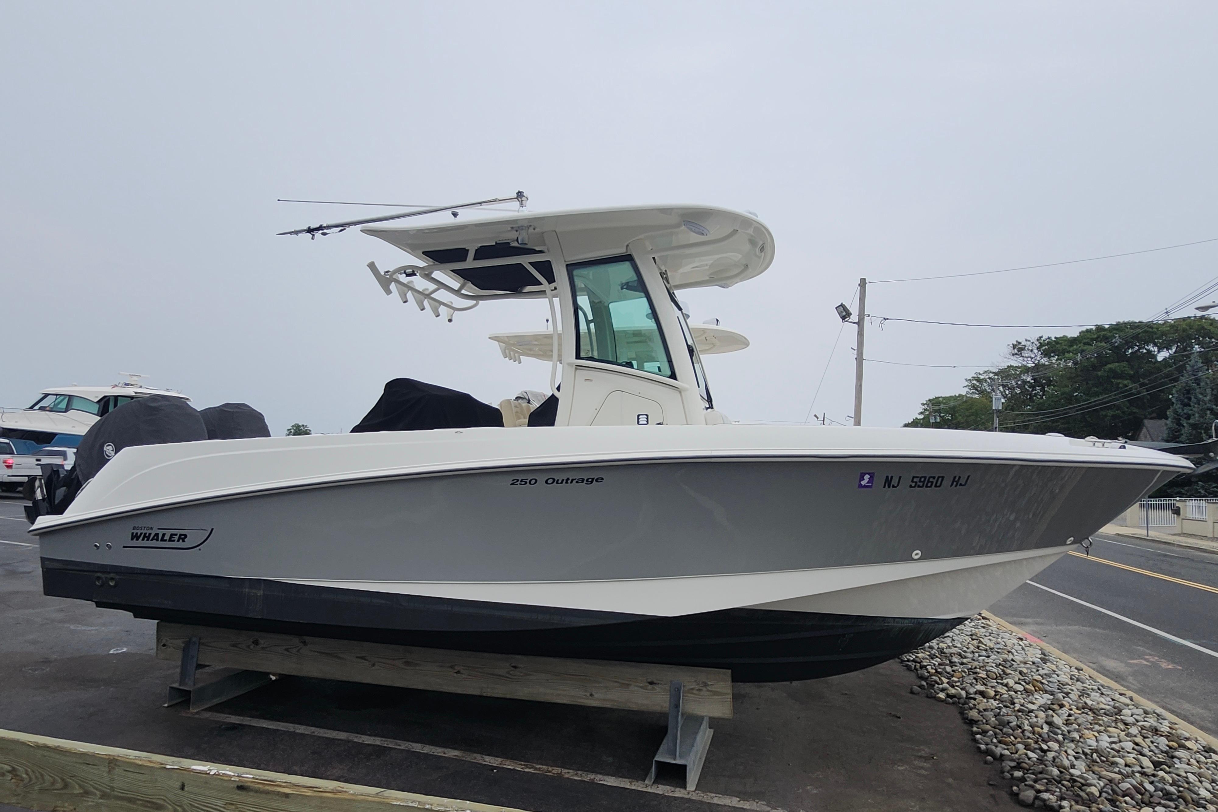 Boston Whaler 250 Outrage 2016 Boston Whaler 250 Outrage boat on display in a parking lot.