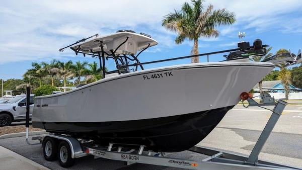 Sea Born SX239 Offshore 2023 Sea Born SX239 Offshore boat on trailer, parked near palm trees.