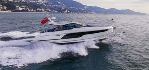 Fairline Targa 40 2025 Fairline Targa 40 yacht cruising on open water with scenic mountain backdrop.