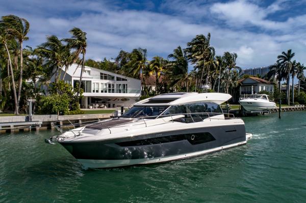 Prestige 520S 2019 Prestige 520S yacht cruising near waterfront homes with palm trees.