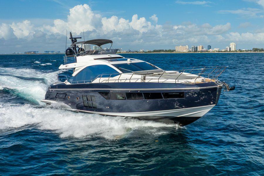 Azimut S7 Luxury 2019 Azimut S7 yacht cruising on open water, city skyline in background.