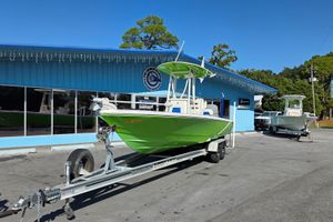 Pathfinder 2600 HPS 2015 Pathfinder 2600 HPS boat in bright green on trailer, outside dealership.