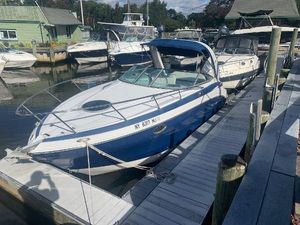 Crownline 264 CR 2013 Crownline 264 CR boat docked at a marina, surrounded by other vessels.