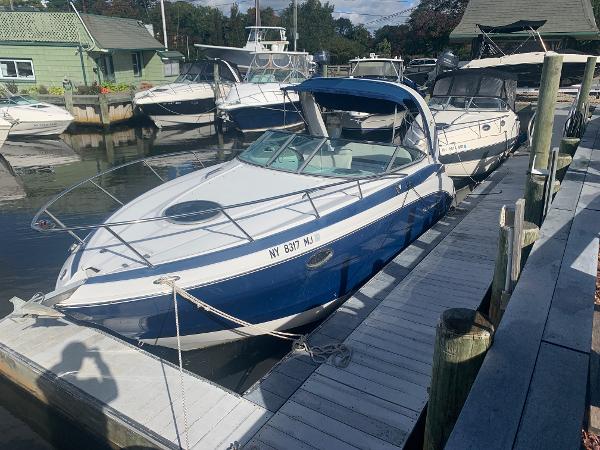 Crownline 264 CR 2013 Crownline 264 CR boat docked at a marina, surrounded by other vessels.