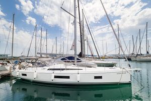 Beneteau Oceanis 51.1 2018 Beneteau Oceanis 51.1 sailboat docked in a marina under a partly cloudy sky.