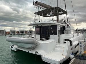 Bali 4.3 2021 Bali 4.3 catamaran docked, featuring spacious deck and modern design under cloudy skies.