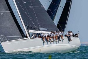 Nautor Swan 45 Sailing crew on 2002 Nautor Swan 45 yacht racing in open water.