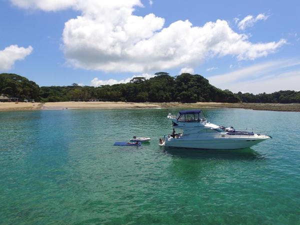 Sea Ray 435 2003 Sea Ray 435 yacht anchored in clear turquoise water near a sandy beach.
