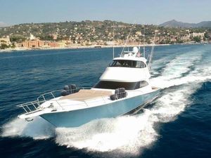 Viking 62 Enclosed Bridge 2018 Viking 62 Enclosed Bridge yacht cruising on open water near scenic coastline.