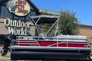 Ranger Reata 220FC 2025 Ranger Reata 220FC pontoon boat displayed outside Bass Pro Shops.