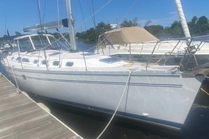 Catalina 470 2007 Catalina 470 sailboat docked at marina under clear blue sky.