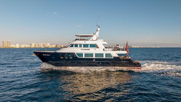 MCP Tri-Deck Luxury 2007 MCP Tri-Deck yacht cruising on open water, city skyline in background.