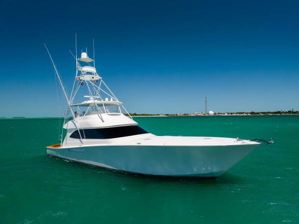 Viking 70 Convertible 2011 Viking 70 Convertible yacht on turquoise water under clear blue sky.