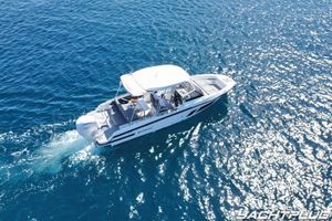 Quarken 27 T-Top 2022 Quarken 27 T-Top boat cruising on sparkling blue water.