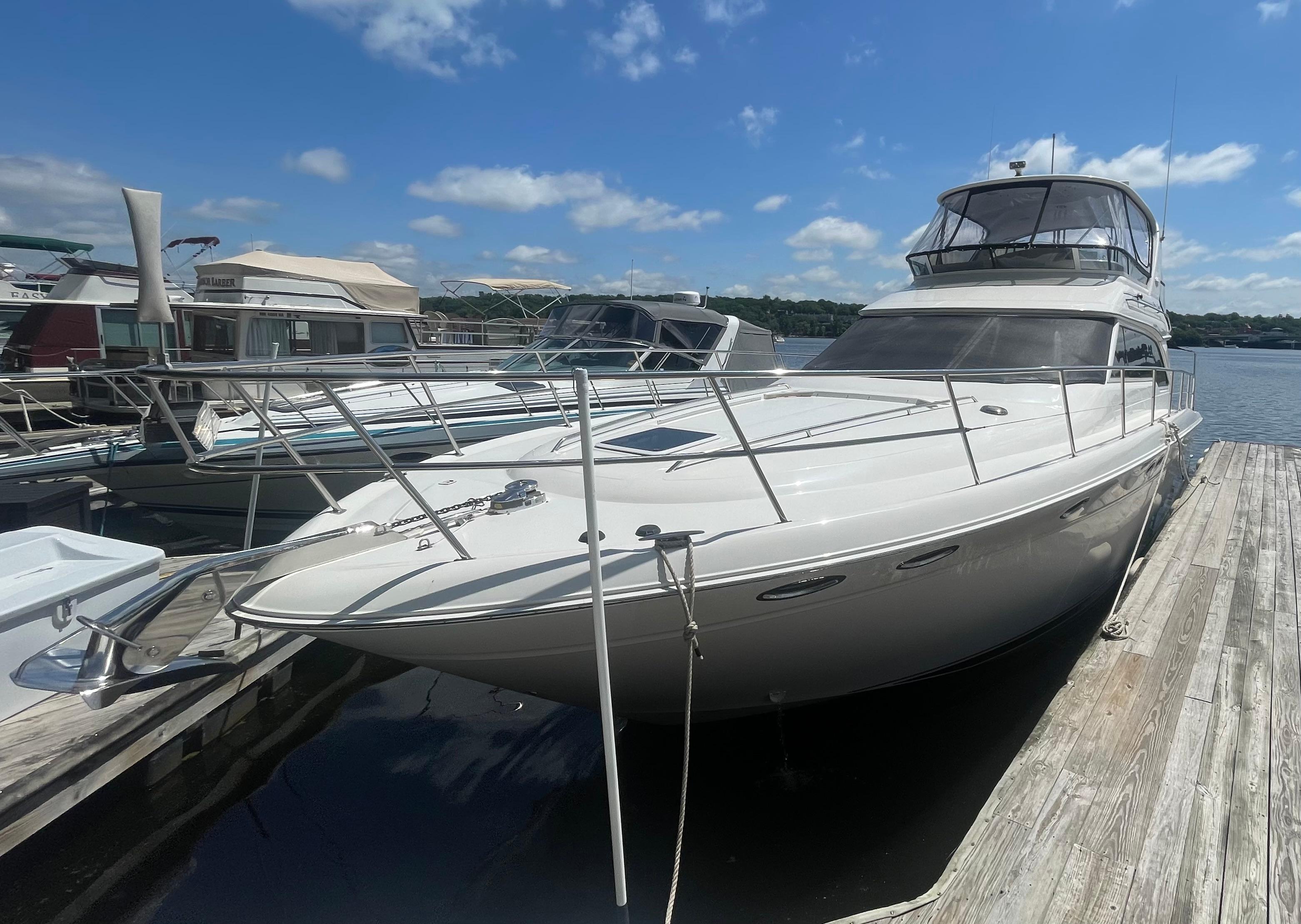 Sea Ray 480 Sedan Bridge 2001 Sea Ray 480 Sedan Bridge yacht docked at marina under blue sky.