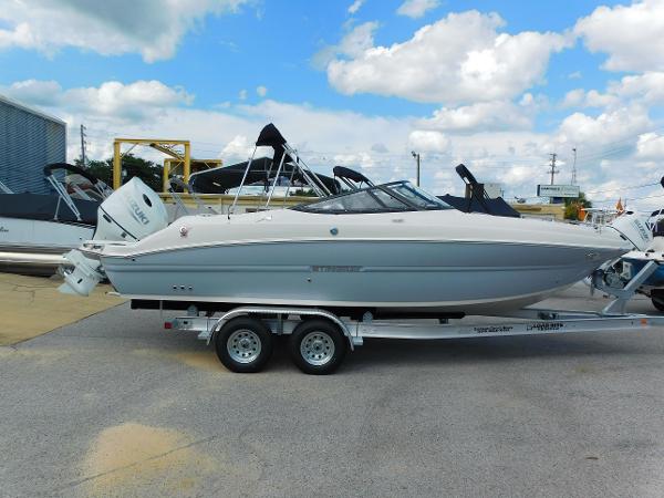Stingray 231 DC 2024 Stingray 231 DC boat on trailer under cloudy sky.