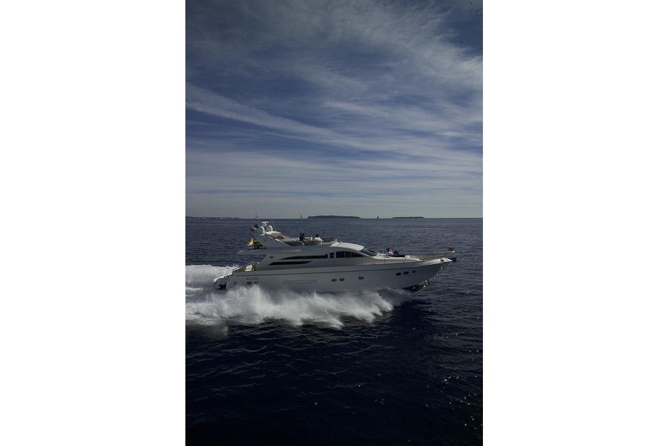 VZ 68 Luxury yacht VZ 68 cruising on open sea under a cloudy sky, 2004 model.