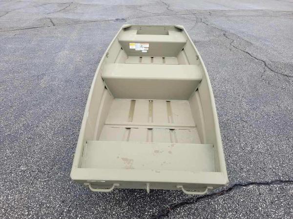 Tracker Grizzly 14 Jon 2025 Tracker Grizzly 14 Jon boat on asphalt surface, showcasing interior seating and storage.