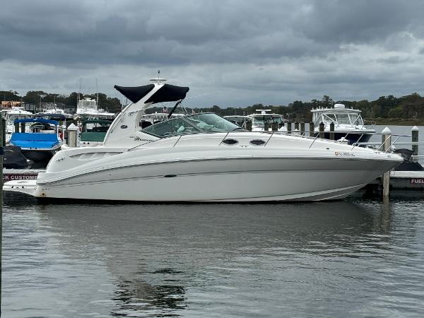 Sea Ray 320 Sundancer 2003 Sea Ray 320 Sundancer yacht docked at marina under cloudy skies.