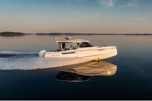 Saxdor 400 GTO 2024 Saxdor 400 GTO cruising on calm water at sunset.