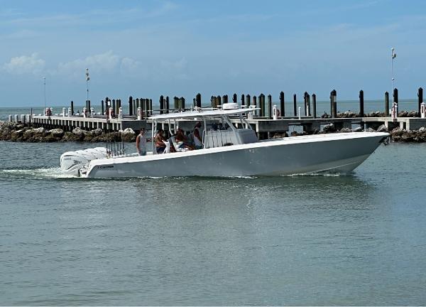 Contender 44 ST 2021 Contender 44 ST boat cruising near a pier on a sunny day.