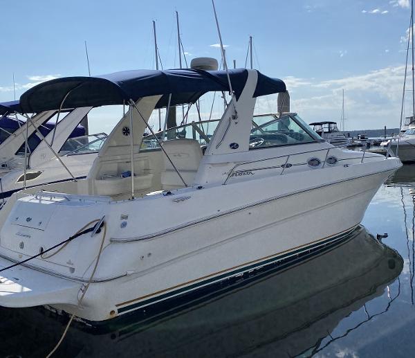 Sea Ray 310 Sundancer 2001 Sea Ray 310 Sundancer boat docked in marina, featuring sleek design and blue canopy.