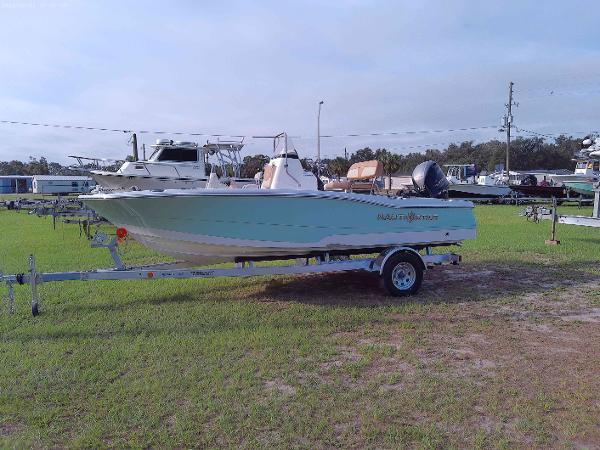 NauticStar 191 2025 NauticStar 191 boat on trailer in grassy area.