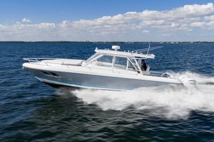 Intrepid 400 Cuddy 2016 Intrepid 400 Cuddy cruising on open water under a clear blue sky.