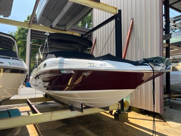 Sea Ray 290 Sundeck 2008 Sea Ray 290 Sundeck boat in storage, maroon and white exterior.
