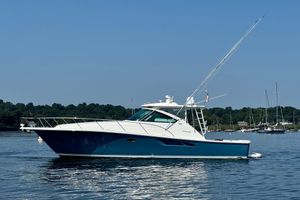 Tiara Yachts 4300 Open 2019 Tiara Yachts 4300 Open cruising on calm waters under clear blue sky.