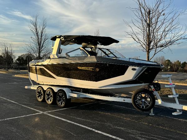 Nautique Super Air Nautique G23 2025 Nautique Super Air Nautique G23 boat on trailer, parked outdoors.