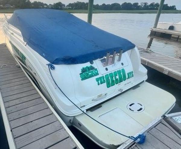 Sea Ray 245 Weekender 2000 Sea Ray 245 Weekender boat docked with blue cover, rear view.