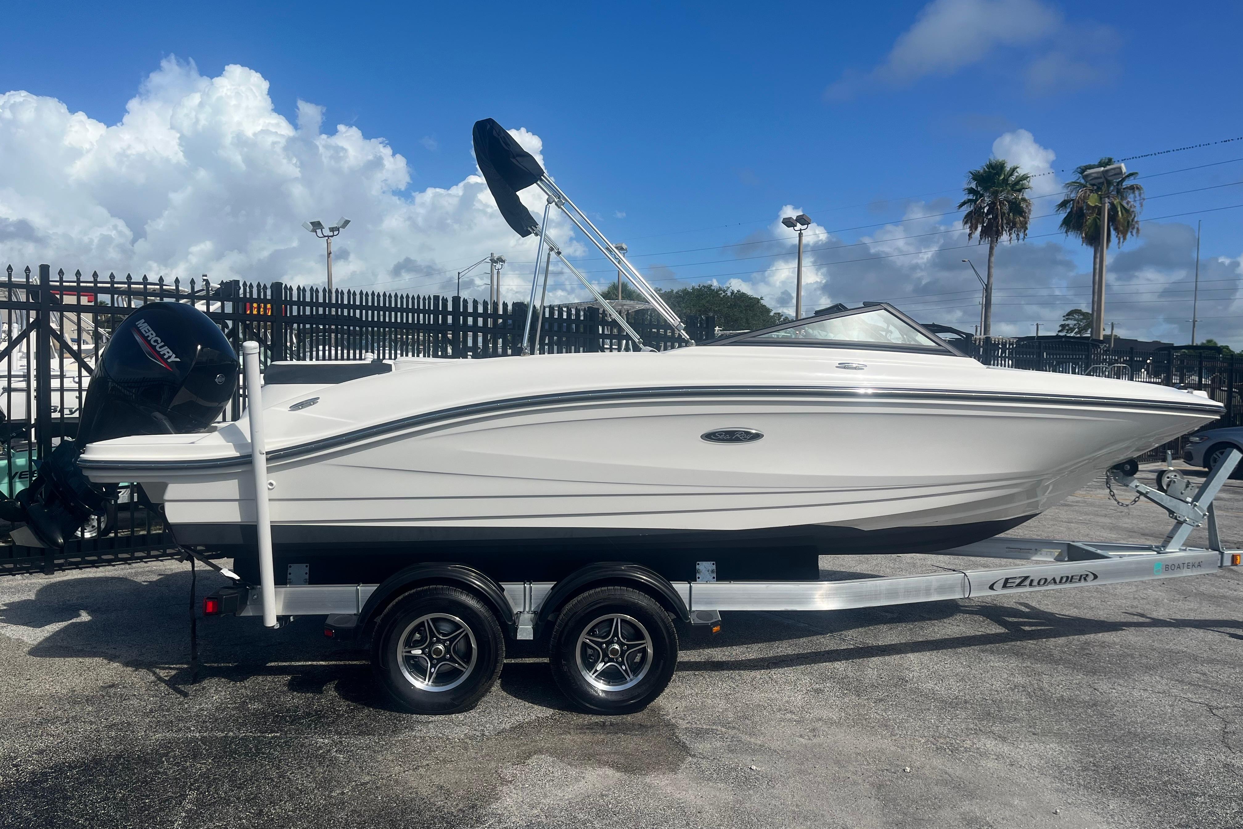 Sea Ray SPX 210 Outboard 2022 Sea Ray SPX 210 Outboard boat on trailer under blue sky.