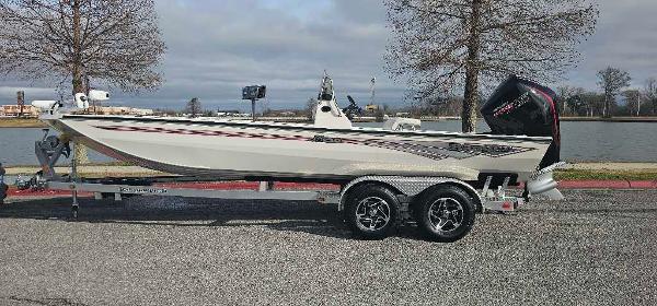 Ranger RB210 2025 Ranger RB210 boat on trailer by a lake, featuring sleek design and powerful engine.