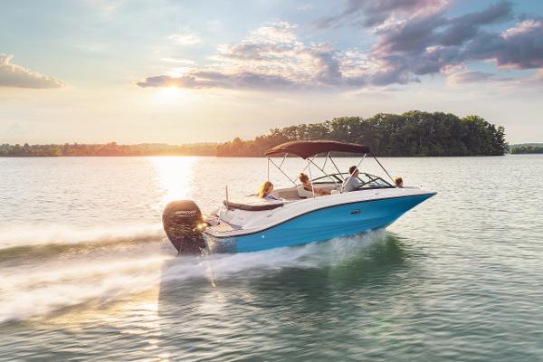 Sea Ray SPX 210 Outboard 2023 Sea Ray SPX 210 Outboard cruising on a serene lake at sunset.