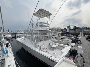 Luhrs 320 Open 1995 Luhrs 320 Open boat docked at marina, featuring a spacious deck and tower.