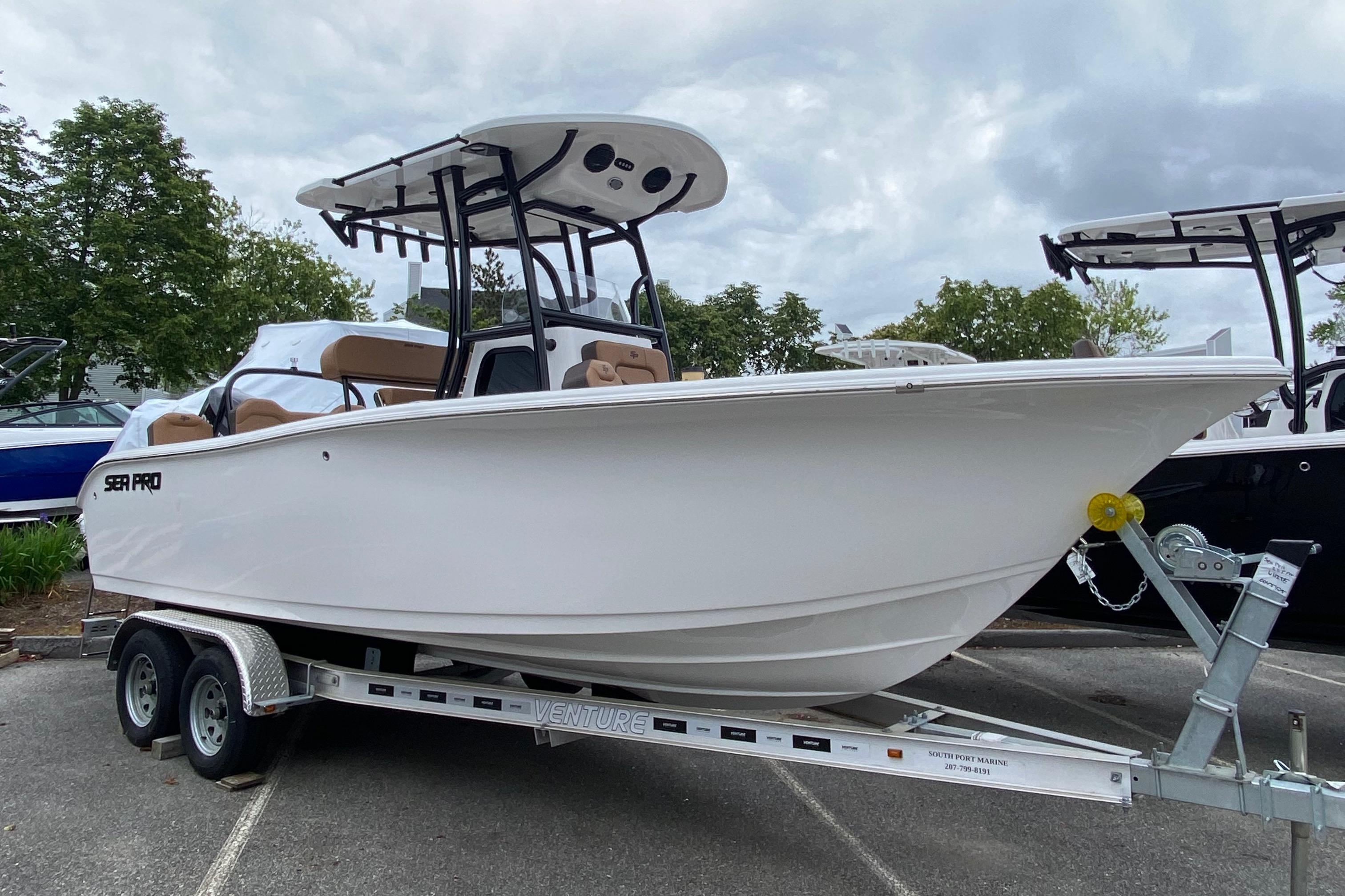 Sea Pro 225 Sandbar 2025 Sea Pro 225 Sandbar boat on trailer, parked outdoors under cloudy sky.