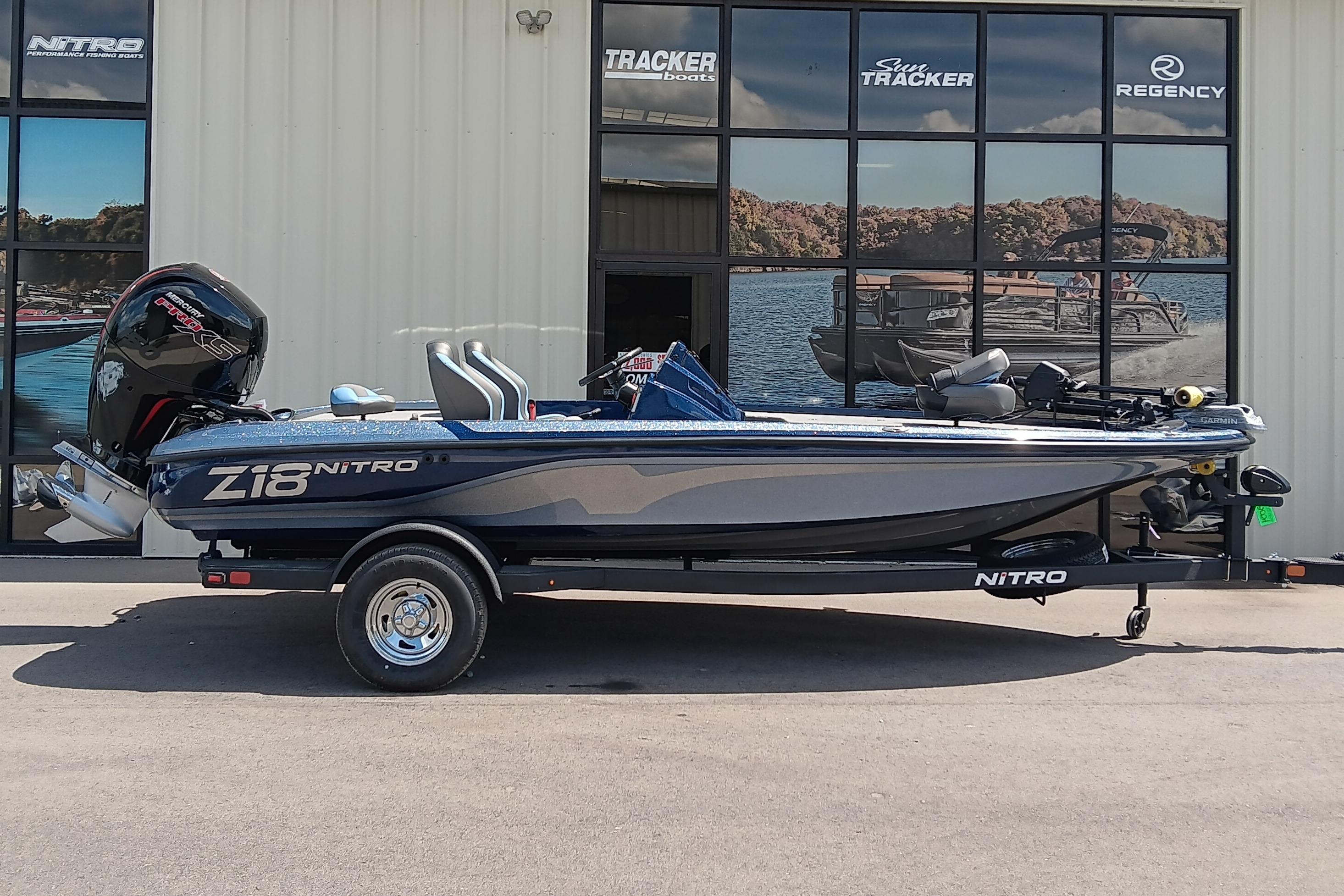 Nitro Z18 2026 Nitro Z18 boat parked outside dealership, showcasing sleek design and powerful engine.