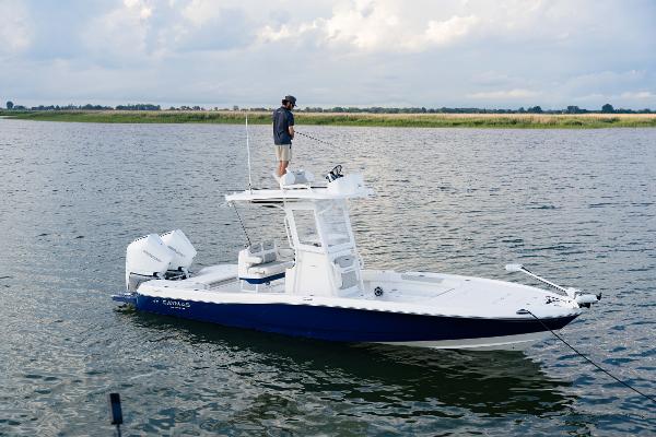 Caymas 28 HB Twin 2022 Caymas 28 HB Twin boat on water with person fishing.