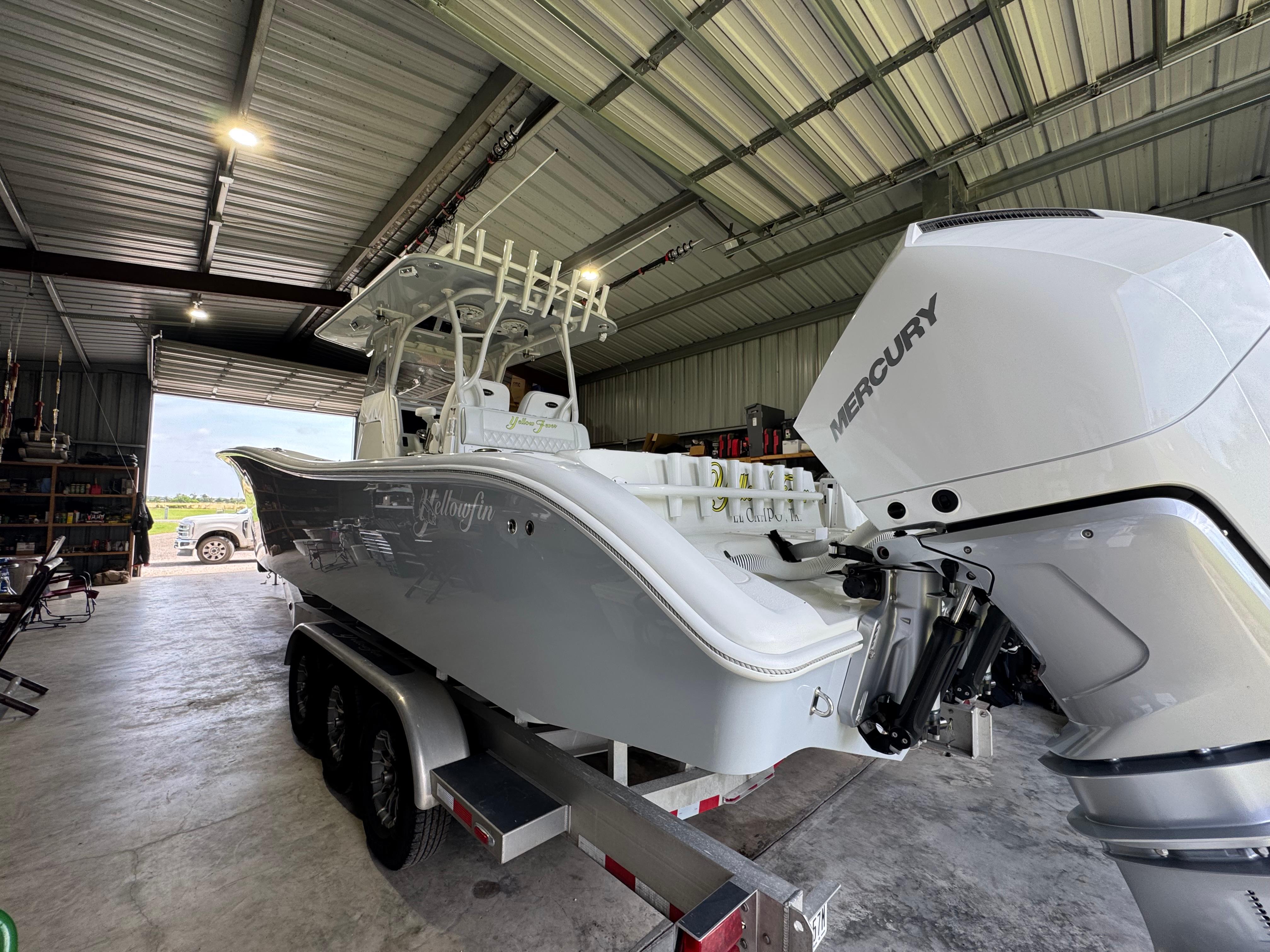 Yellowfin 36 Offshore 2020 Yellowfin 36 Offshore boat in a garage, featuring a Mercury engine.