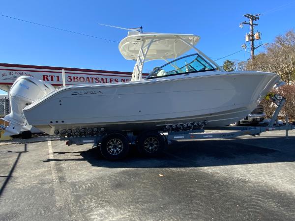 Cobia 280 Dual Console 2025 Cobia 280 Dual Console boat on trailer at dealership.