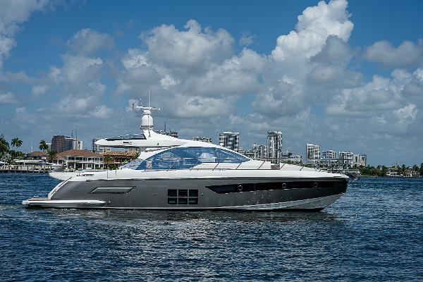 Azimut S6 2022 Azimut S6 yacht cruising on a sunny day with city skyline in the background.