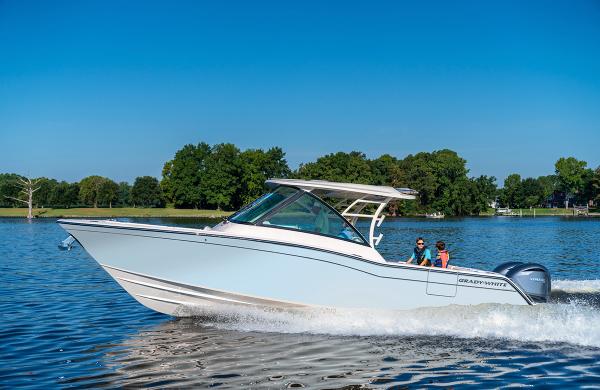Grady-White 325 2025 Grady-White 325 boat cruising on a lake with two passengers onboard.