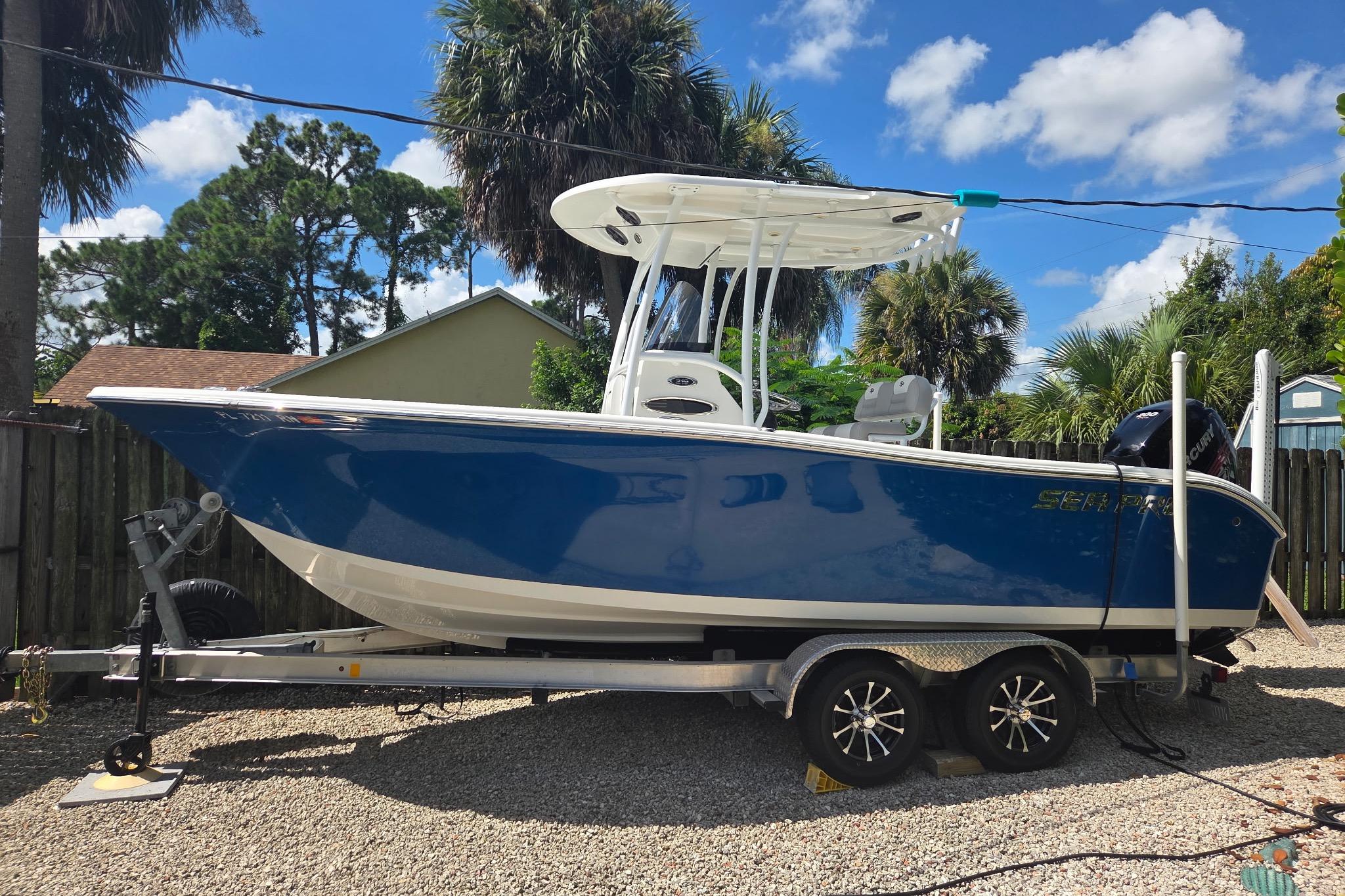 Sea Pro 219 Center Console 2018 Sea Pro 219 Center Console boat on trailer, parked outdoors under blue sky.