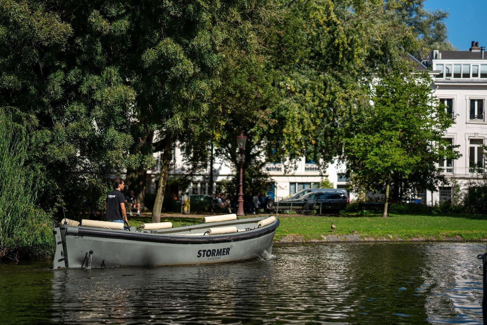 Stormer Lifeboat 75 2025 Stormer Lifeboat 75 on a serene river, surrounded by lush greenery and buildings.