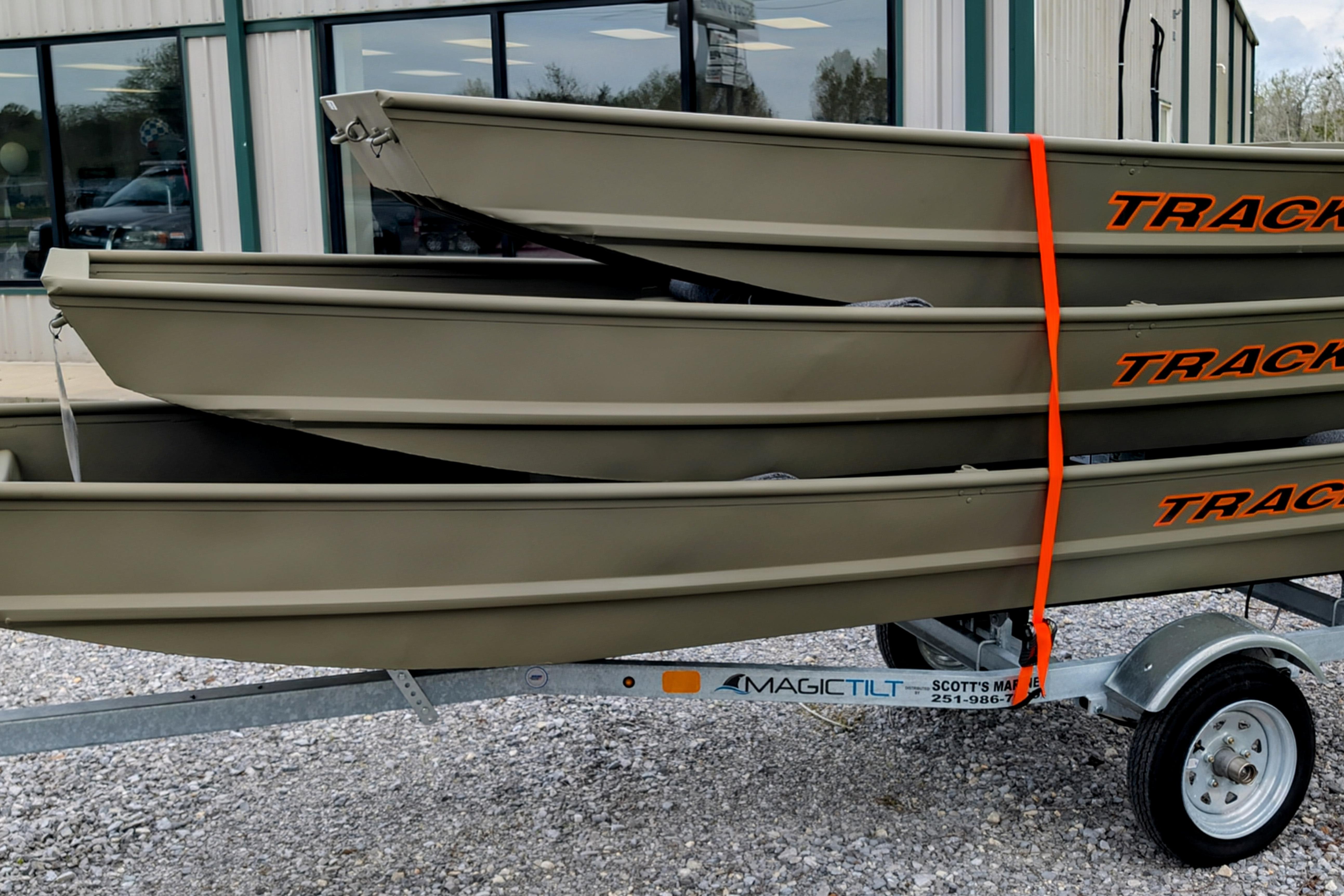 Tracker Grizzly 14 Jon 2026 Tracker Grizzly 14 Jon boats stacked on trailer outside a building.